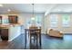 Bright open-concept living space with hardwood floors, dining area, and a view of the backyard at 120 Park Village Dr, Canton, GA 30114