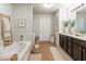 Relaxing main bathroom with a soaking tub, double vanity, and modern finishes at 120 Park Village Dr, Canton, GA 30114