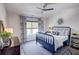 Charming bedroom featuring a navy metal frame bed, blue accents, and a ceiling fan at 14 Lochurst Ln # 153, Roswell, GA 30076