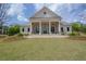 The Harlow Hall clubhouse features a well-manicured lawn and classic architectural design at 14 Lochurst Ln # 153, Roswell, GA 30076