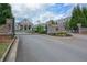 Gated entrance to Harlow Hall, flanked by brick pillars and lush greenery at 14 Lochurst Ln # 153, Roswell, GA 30076