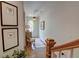 Bright foyer with hardwood floors, stairway, decorative lighting, and framed prints at 14 Lochurst Ln # 15, Roswell, GA 30076