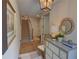 Bright foyer with hardwood floors, stairway, decorative mirror and chest creating an inviting entry space at 14 Lochurst Ln # 15, Roswell, GA 30076
