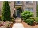 Charming brick home entrance with landscaped garden and stairs to the front door at 14 Lochurst Ln # 153, Roswell, GA 30076