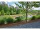 Picturesque pond view surrounded by lush greenery in a serene community setting at 14 Lochurst Ln # 153, Roswell, GA 30076