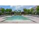 A refreshing community pool with ample seating, surrounded by lush landscaping and townhomes at 14 Lochurst Ln # 153, Roswell, GA 30076