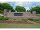 Community entrance sign featuring brick pillars and manicured landscaping at Harlow West at 14 Lochurst Ln # 15, Roswell, GA 30076