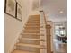 Carpeted stairs leading to the upper level, with a wooden handrail and neutral decor at 14 Lochurst Ln # 15, Roswell, GA 30076