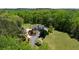Picturesque property showcasing a brick home and detached garage surrounded by lush greenery at 190 Ward Rd, Ellenwood, GA 30294