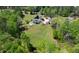 Aerial view showcasing the property with a spacious lawn, complemented by surrounding trees for added privacy at 190 Ward Rd, Ellenwood, GA 30294