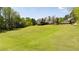 Lush backyard featuring a house with a deck, complemented by mature trees for a serene outdoor experience at 190 Ward Rd, Ellenwood, GA 30294