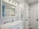 Bathroom with marble countertops, and a view to shower over tub at 190 Ward Rd, Ellenwood, GA 30294