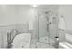 Modern bathroom with a standalone tub, glass-enclosed shower, and marble-look tile at 190 Ward Rd, Ellenwood, GA 30294