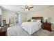 Primary bedroom featuring plush carpet, ceiling fan, a large window and ensuite bathroom at 190 Ward Rd, Ellenwood, GA 30294