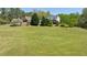 Expansive lawn leading to a charming home with a detached garage, offering ample space and curb appeal at 190 Ward Rd, Ellenwood, GA 30294