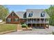 Classic brick home with a covered porch and well-manicured lawn at 190 Ward Rd, Ellenwood, GA 30294