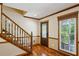 Inviting foyer featuring hardwood floors, a staircase, and a window view to the outside at 190 Ward Rd, Ellenwood, GA 30294
