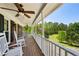 Comfortable front porch with rocking chairs, offering a peaceful spot to enjoy the surrounding landscape at 190 Ward Rd, Ellenwood, GA 30294