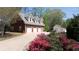 Three-car garage with ample parking space, situated near well-maintained landscaping and lush greenery at 190 Ward Rd, Ellenwood, GA 30294