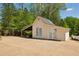 Exterior view of a quaint detached garage with double doors, offering additional storage or workspace at 190 Ward Rd, Ellenwood, GA 30294