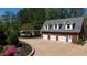 Spacious three-car garage with additional parking, set amidst beautifully landscaped surroundings at 190 Ward Rd, Ellenwood, GA 30294