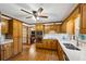 Open kitchen featuring quartz counters, wooden cabinetry, stainless appliances, and hardwood floors at 190 Ward Rd, Ellenwood, GA 30294