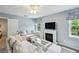 Cozy living room with comfortable seating, a fireplace, and natural light at 190 Ward Rd, Ellenwood, GA 30294