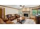 Cozy living room featuring a stone fireplace, hardwood floors, and comfortable seating at 190 Ward Rd, Ellenwood, GA 30294