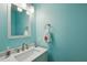 Clean powder room with blue walls, tile backsplash, single sink vanity and chrome faucet at 190 Ward Rd, Ellenwood, GA 30294