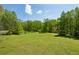 Expansive backyard with lush green grass and mature trees, offering serene outdoor living at 190 Ward Rd, Ellenwood, GA 30294