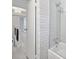 Bright bathroom featuring white subway tile in shower, and a staircase leading to the living area at 285 Lakemoore Ne Dr # A, Atlanta, GA 30342
