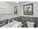 Modern bathroom with stylish stone accent wall, white sink, toilet, and framed artwork at 285 Lakemoore Ne Dr # A, Atlanta, GA 30342