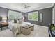 Well-lit primary bedroom features stylish decor, a cozy bed, and large windows with natural light at 285 Lakemoore Ne Dr # A, Atlanta, GA 30342