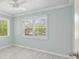 Airy bedroom featuring neutral walls, wood look flooring, and large window letting in natural light at 285 Lakemoore Ne Dr # A, Atlanta, GA 30342