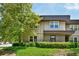 Exterior view of a well-maintained home with neat landscaping, a large tree, and a blue sky at 285 Lakemoore Ne Dr # A, Atlanta, GA 30342