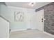 Entryway featuring a modern light fixture, stairs, and decorative wall art, with grey stacked stone accent wall at 285 Lakemoore Ne Dr # A, Atlanta, GA 30342