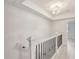 Bright hallway featuring white trim and wrought iron staircase with a modern chandelier lighting the way at 285 Lakemoore Ne Dr # A, Atlanta, GA 30342