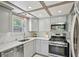 Bright kitchen featuring stainless steel appliances, subway tile backsplash, gray cabinets, and a window at 285 Lakemoore Ne Dr # A, Atlanta, GA 30342