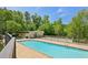 Community pool surrounded by lush green trees and landscaping, providing a peaceful setting at 285 Lakemoore Ne Dr # A, Atlanta, GA 30342