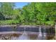 A scenic water feature with a natural dam and lush green surroundings at 285 Lakemoore Ne Dr # A, Atlanta, GA 30342
