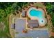 Overhead shot of community pool with clubhouse, picnic pavilion, parking lot, and extensive manicured green spaces at 3049 Ivy Crossing Dr, Buford, GA 30519