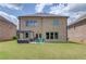 Beautiful brick home featuring a cozy patio with a grill and outdoor seating at 3049 Ivy Crossing Dr, Buford, GA 30519