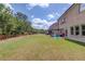 Spacious backyard with a patio, green lawn, and mature trees at 3049 Ivy Crossing Dr, Buford, GA 30519