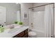 Neutral bathroom with tub-shower combo, white shower curtain, and dark wood vanity at 3049 Ivy Crossing Dr, Buford, GA 30519