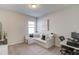 This flex space offers carpet, a window, white sofa, and is perfect for a home office at 3049 Ivy Crossing Dr, Buford, GA 30519