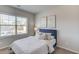 Carpeted bedroom with blue upholstered headboard, window views, and light neutral color scheme at 3049 Ivy Crossing Dr, Buford, GA 30519