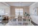 Elegant dining room with hardwood floors, stylish lighting, and ample seating at 3049 Ivy Crossing Dr, Buford, GA 30519