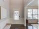 Bright foyer featuring hardwood floors, a bench, and a view of a window at 3049 Ivy Crossing Dr, Buford, GA 30519