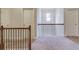 Upstairs landing with a view of the window and doors leading to the bedrooms at 3049 Ivy Crossing Dr, Buford, GA 30519