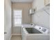 Bright laundry room features new appliances, shelving, and a window for natural light at 3049 Ivy Crossing Dr, Buford, GA 30519